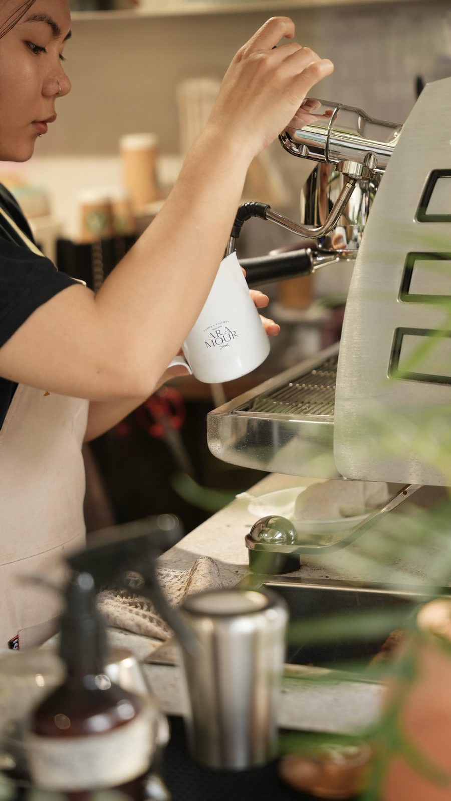 A barista pulling a shot at the espresso machine