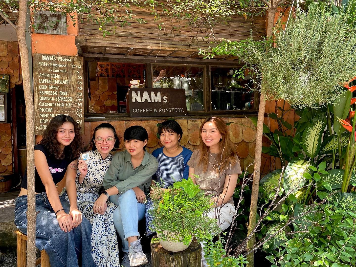 A group at the plant-filled entrance