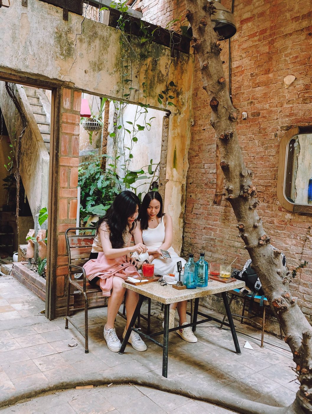 Lush garden; vine-covered exterior, courtyard interior, candid customers
