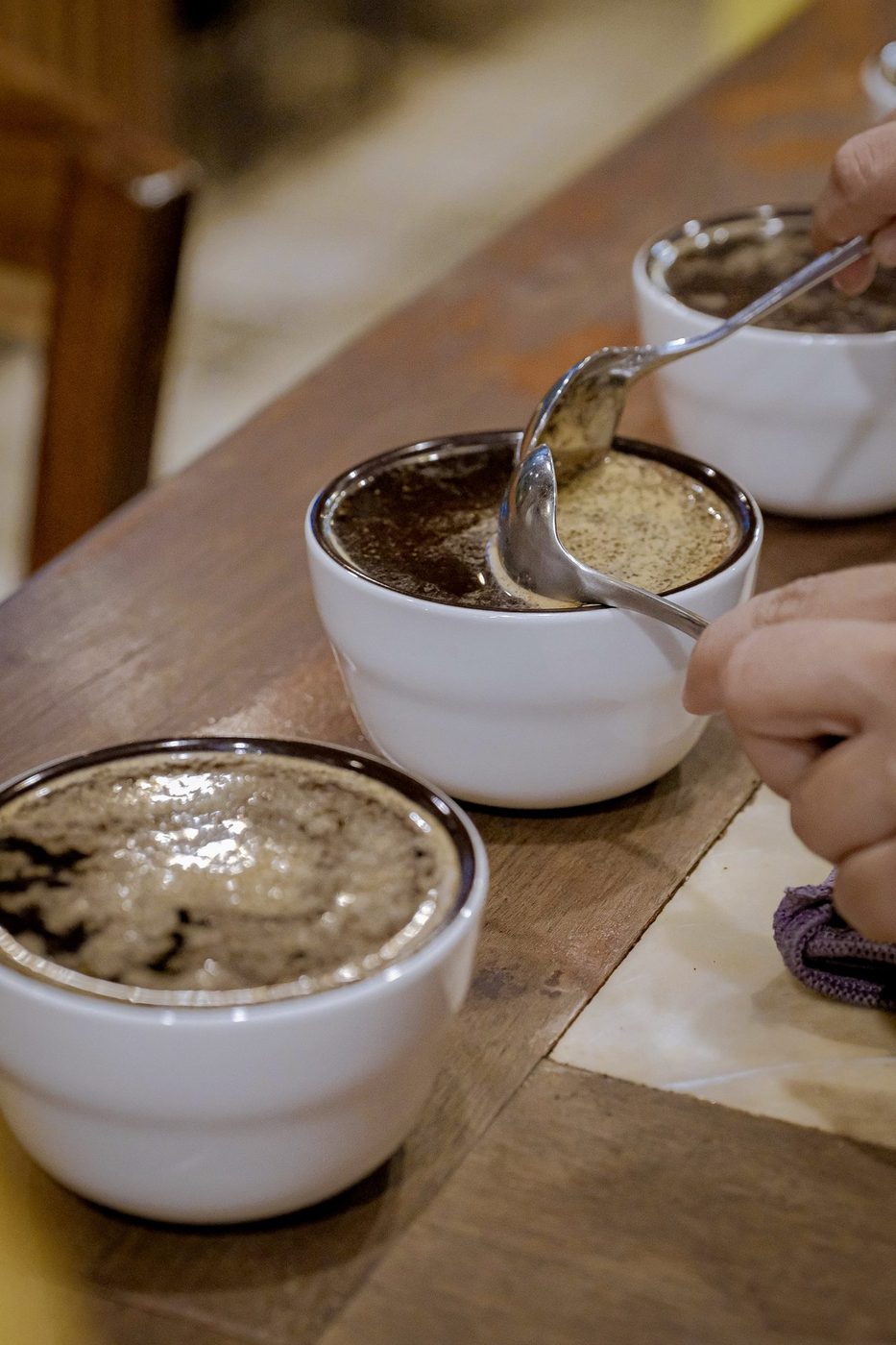 Gesha cupping workshop; grinding, cupping bowls, event banner