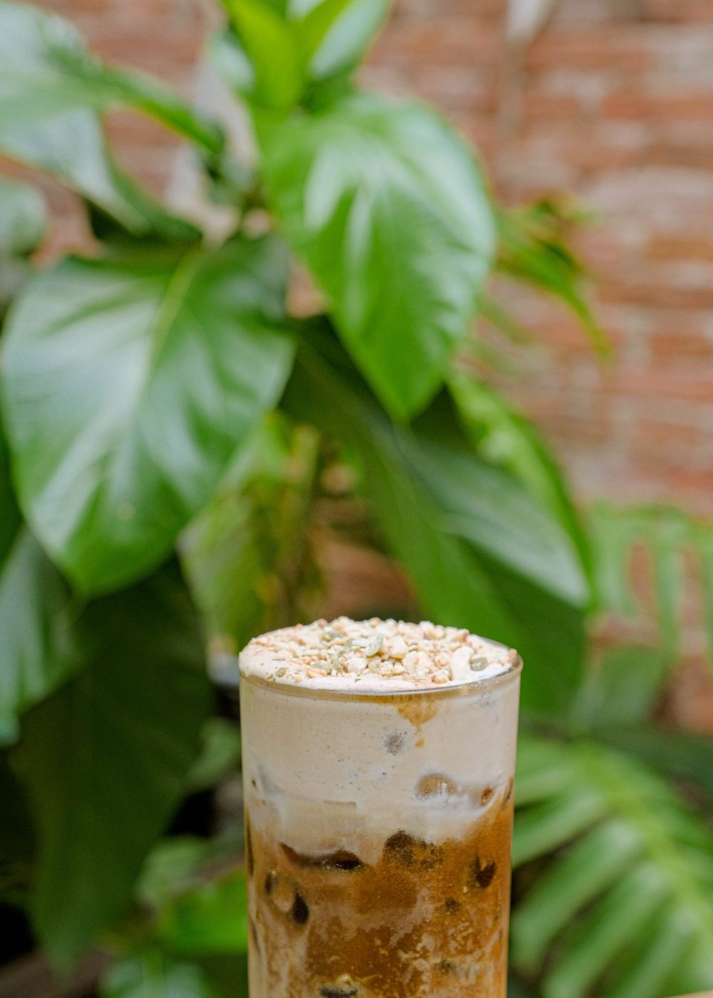 Signature iced drink with nut topping, natural outdoor light