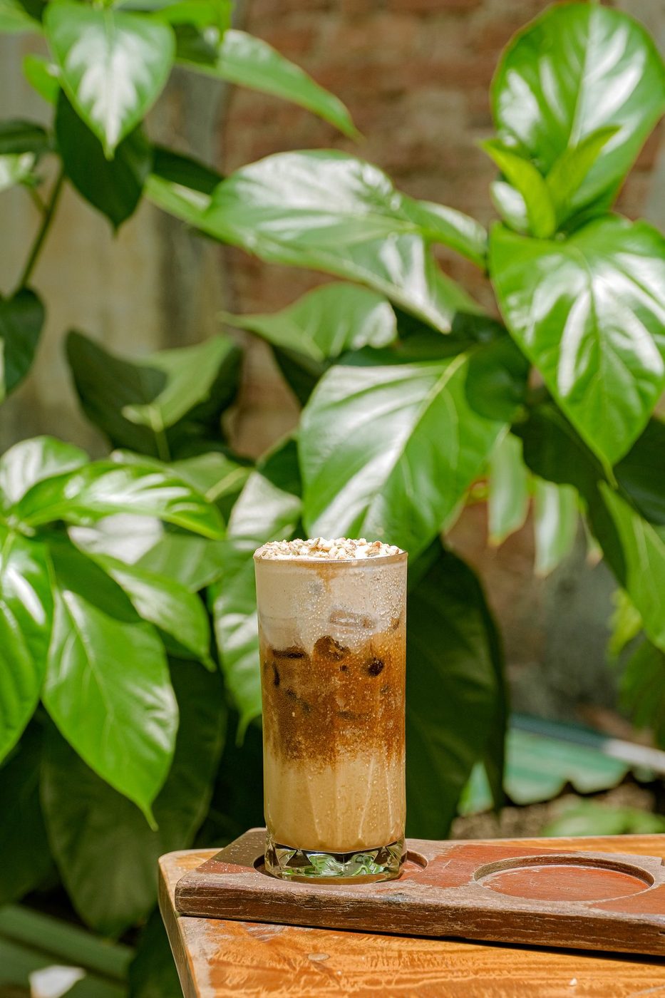 Signature iced drink with nut topping, natural outdoor light