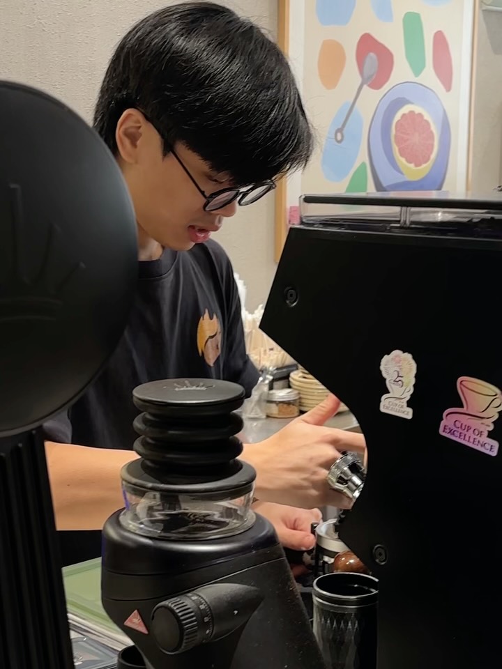 A barista at the espresso machine