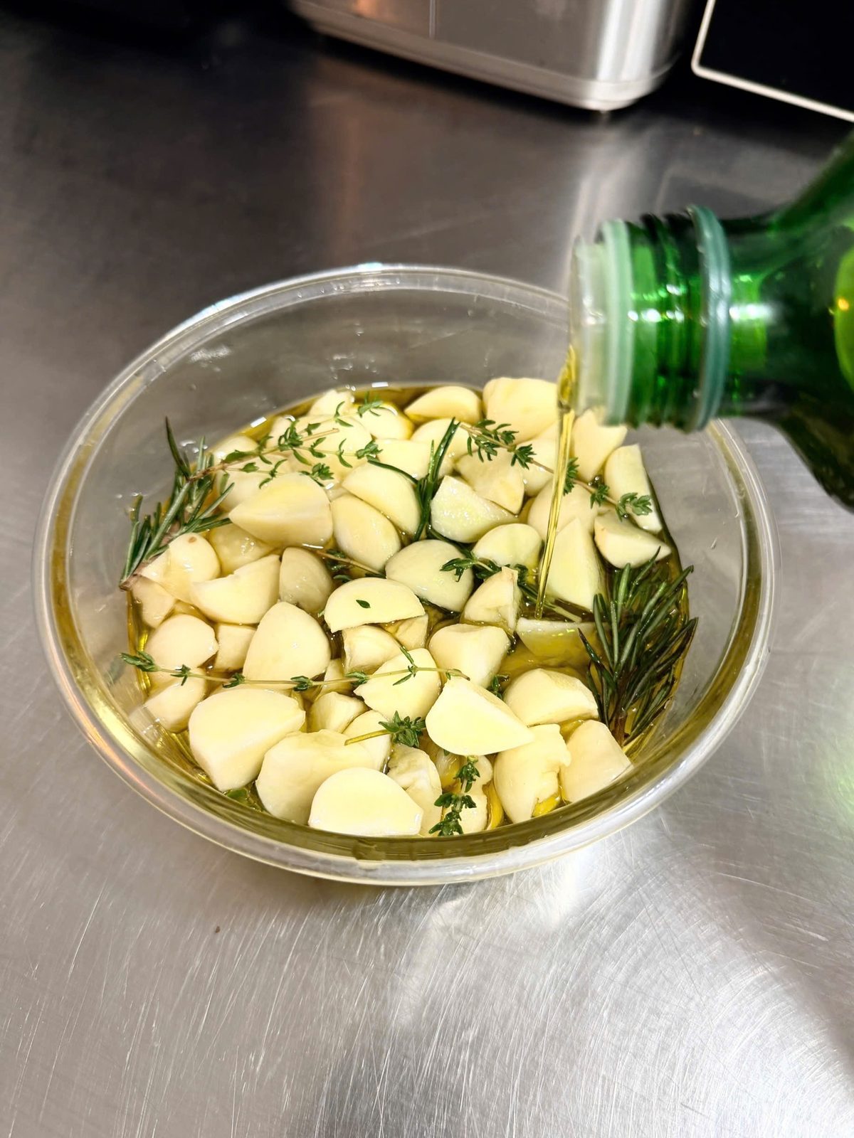 Kitchen prep: garlic and herbs in confit oil — not a drink, despite the filename