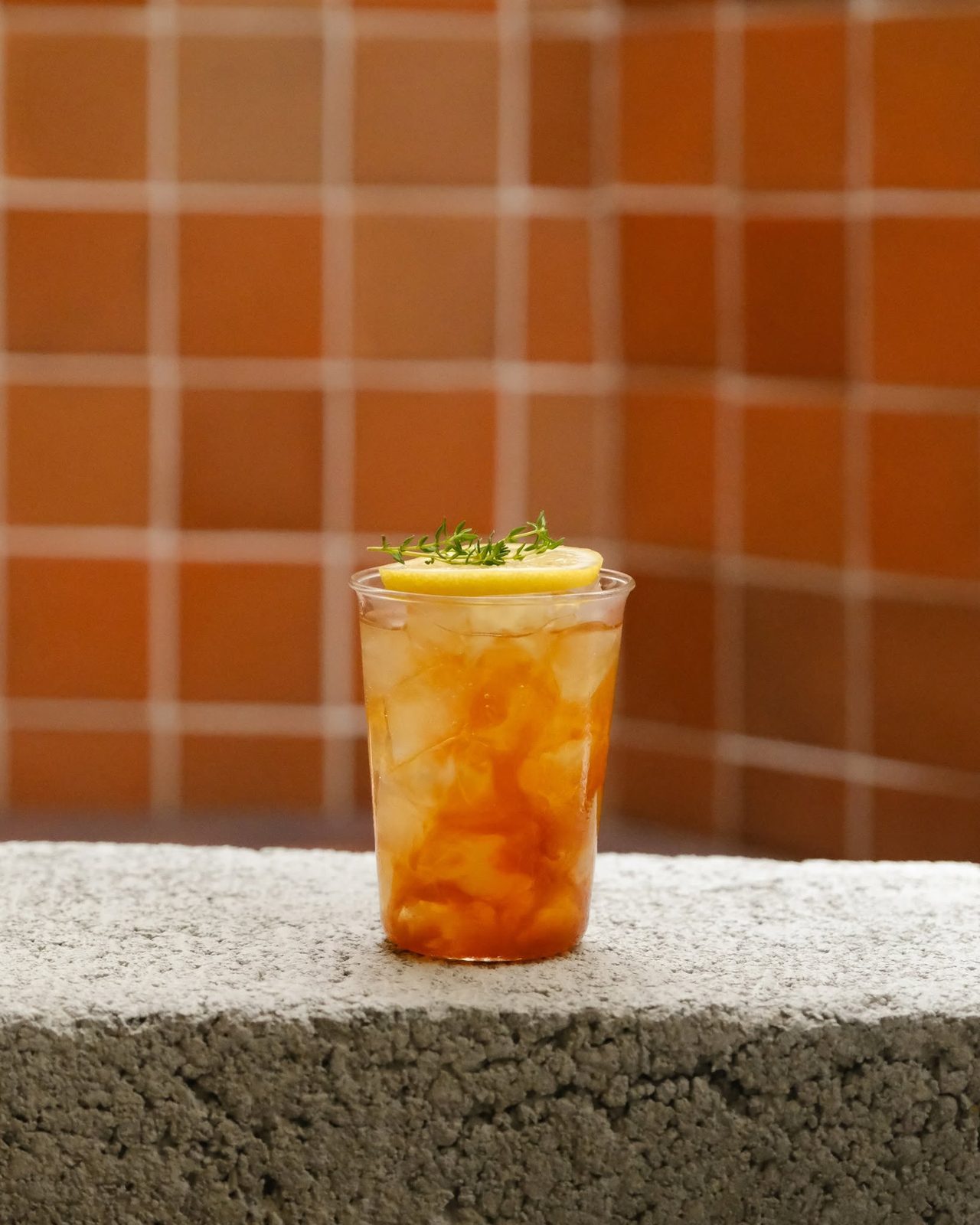 Iced tea against a terracotta-tiled wall