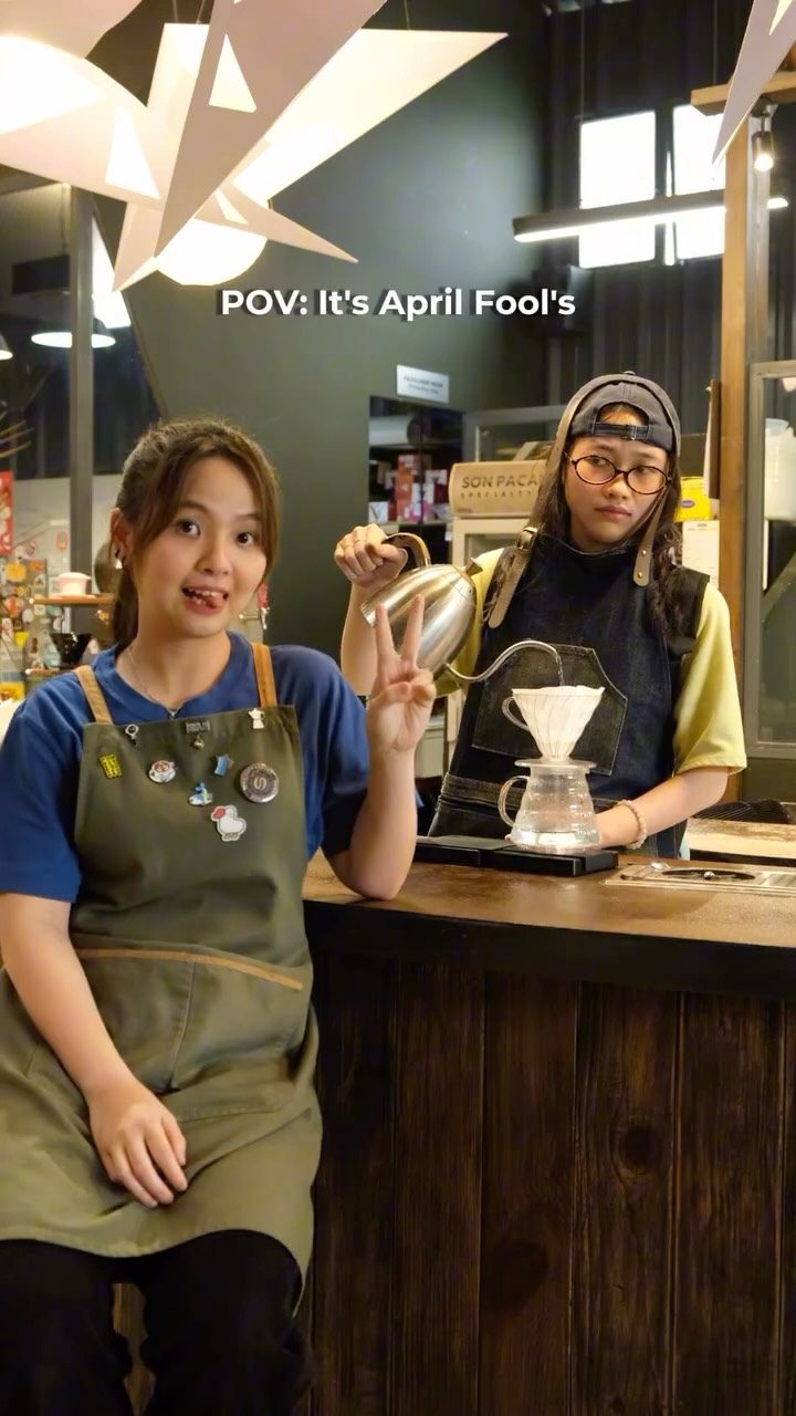 A barista on a pour-over behind the counter