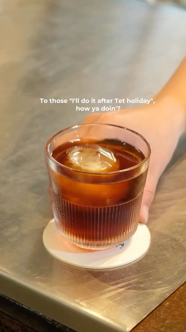 An iced coffee in hand
